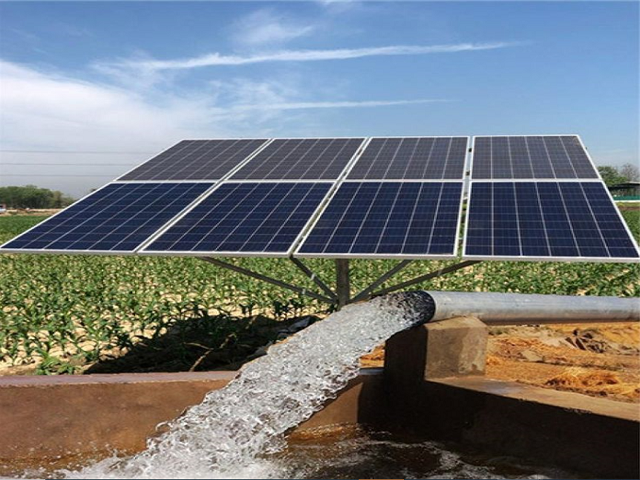 A solar array pumping water onto a farm field
