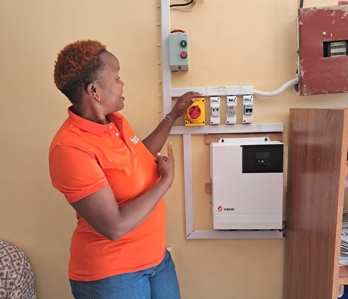 A Go Green Gold technician wiring a hybrid solar inverter